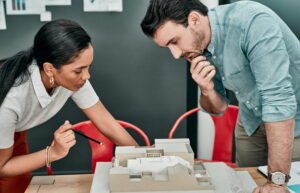 Blog — Construction & Remodeling Insights for Upstate SC | Upstate Construction & Renovation. Construction design team reviewing a scale model and blueprints in Upstate SC